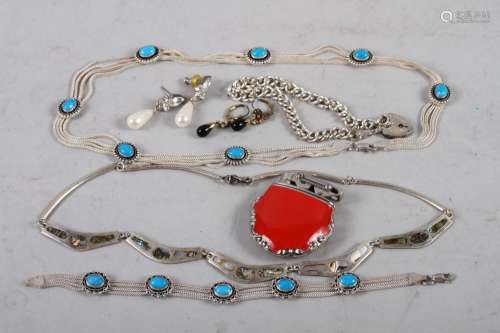A silver bracelet with lock, a silver and turquoise necklace...