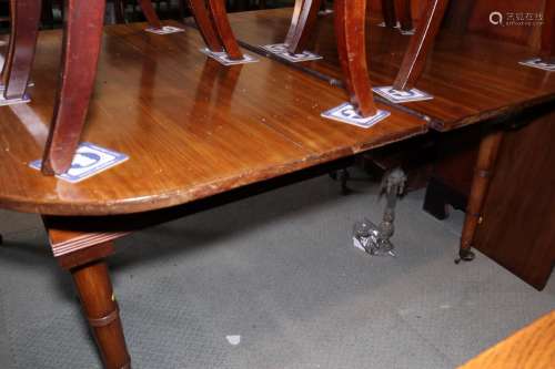 A 19th century mahogany extending dining table with one extr...