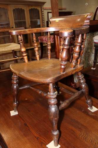 A captains 19th century spindle back elbow chair with elm pa...