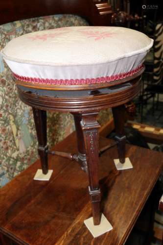 A 19th century carved walnut piano stool with adjustable sea...