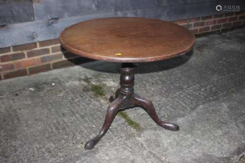 A 19th century mahogany circular tilt top table, on turned c...