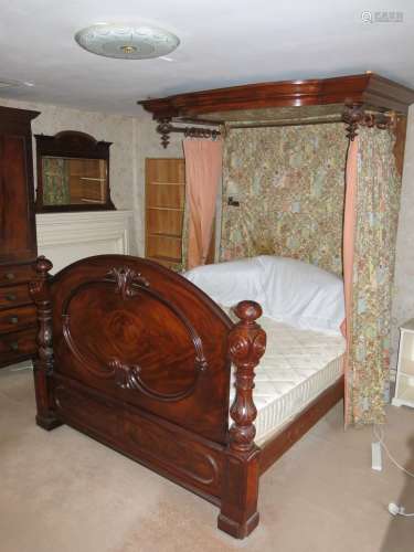 A late Victorian figured mahogany half tester bed with panel...