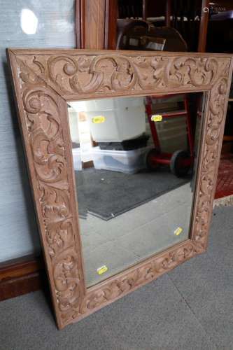 An acanthus carved hardwood framed wall mirror with bevelled...