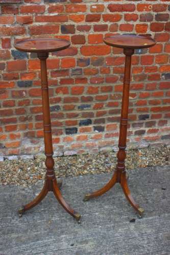 A pair of mahogany torcheres with faux bamboo turned columns...