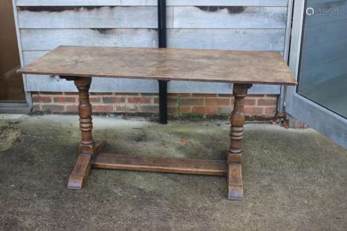 An oak refectory table, on twin turned and stretchered suppo...