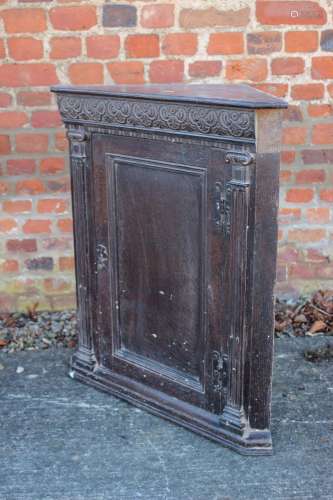 An oak corner hanging cupboard of 17th century design with f...