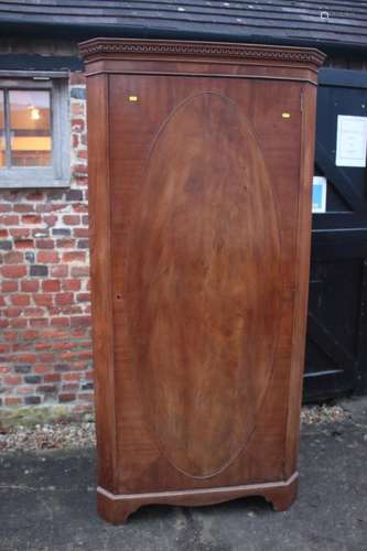 A 1930s figured walnut corner hall wardrobe enclosed oval pa...