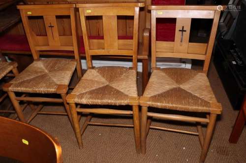 A set of seven chapel chairs with rush envelope seats, on tu...
