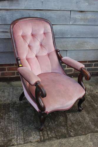 A carved mahogany scroll arm showframe chair, button upholst...