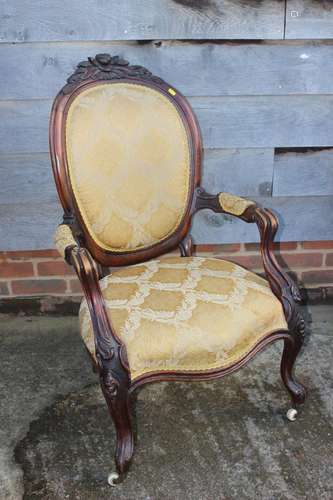 A carved walnut showframe armchair with oval back, upholster...