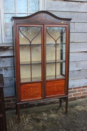 An Edwardian mahogany and inlaid display cabinet enclosed la...