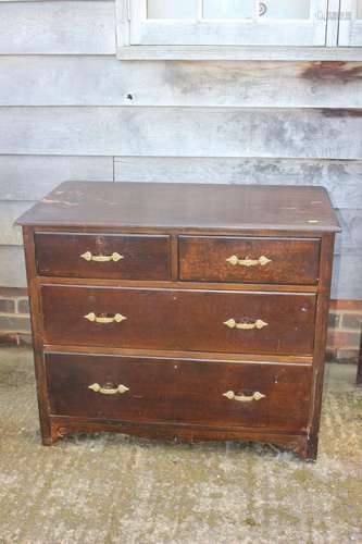 An oak chest of two short and two long drawers with brass ha...