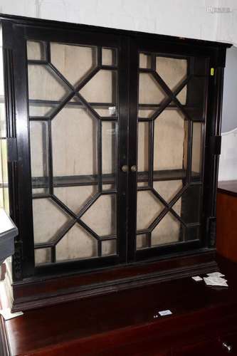 An ebonised bookcase/display cabinet enclosed glazed panel d...