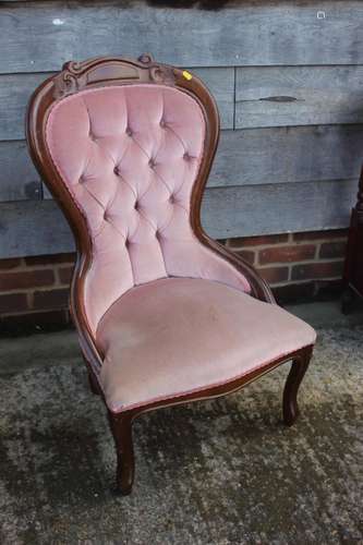 A carved walnut showframe nursing chair, button upholstered ...