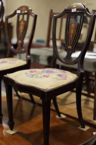 A set of three Sheraton Revival inlaid mahogany salon chairs...