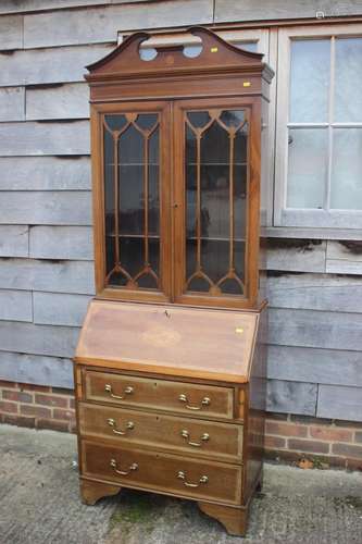 An Edwardian Sheraton design bureau bookcase, fitted three d...