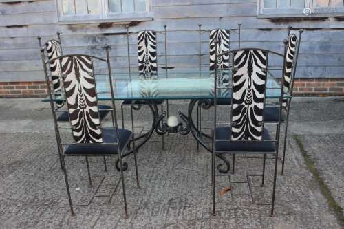 A wrought iron and glass top dining table, 72 wide x 40 deep...