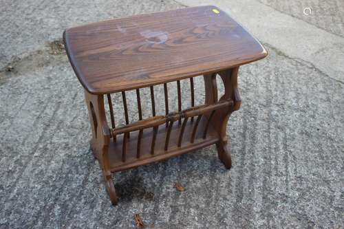 An Ercol polished elm magazine table, 40 wide x 21 deep x 19...