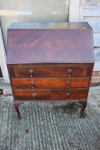 A mahogany fall front bureau, fitted three drawers, on cabri...