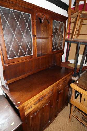 An oak dresser of 17th century design, the upper section fit...