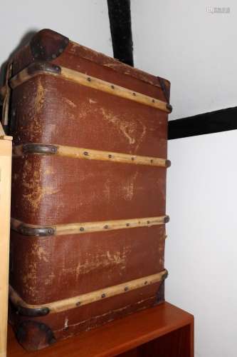 A canvas and wood bound travel trunk