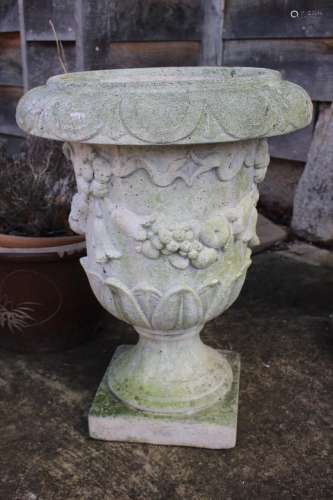 A cast stone urn with swag decoration, 22 high