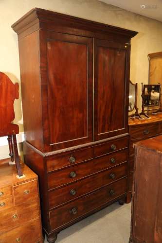 An early 19th century figured mahogany linen press, the uppe...
