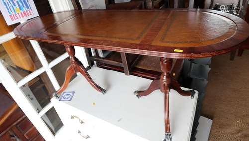 A walnut and leather inset low coffee table, on twin turned ...