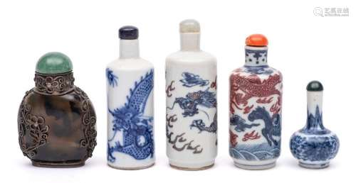 A group of four Chinese porcelain snuff bottles and stoppers...