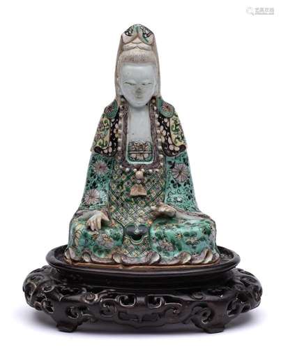 A Chinese famille verte biscuit figure of Guanyin: seated cr...