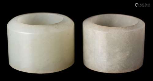 Two Chinese pale celadon jade archers rings: 2.7cm and 3cm d...