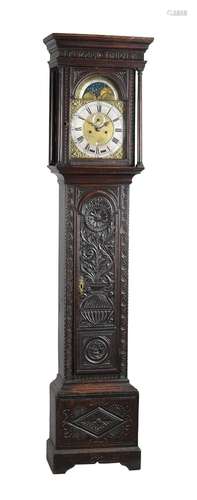 A carved oak longcase clock