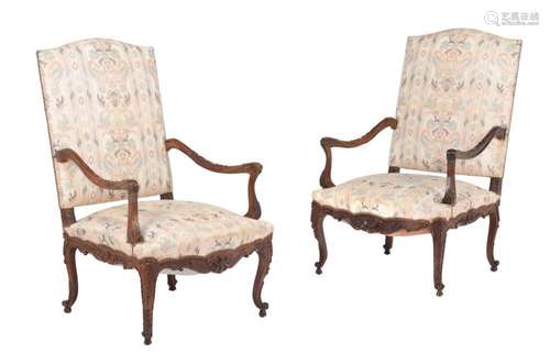 A pair of carved walnut armchairs in Louis XV style