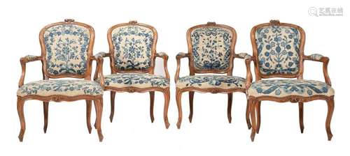 A set of four carved beech and needlework upholstered fauteu...