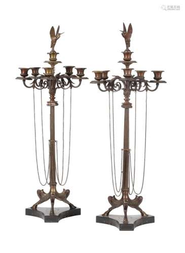 A pair of French patinated and gilt bronze five light candel...