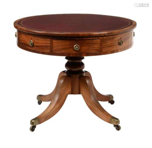 A mahogany library drum table