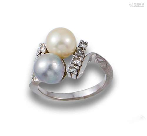 Ring, 1960s, in white gold with two 8 mm. white and grey cal...