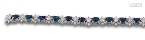 Bracelet, 1970s, in 18kts white gold, sapphires, and diamond...