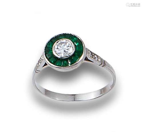 Partridge eye ring in platinum, with diamonds and emeralds.