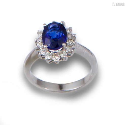 18kt white gold rosette ring with central sapphire and brill...