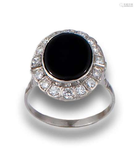 Antique ring in platinum, comprising a central onyx plaque b...