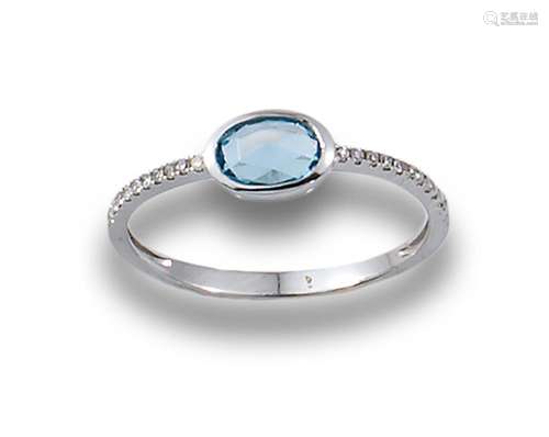 Ring in 18kt white gold with an oval-cut blue topaz and diam...