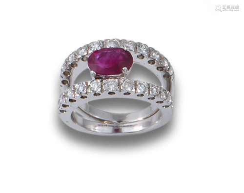 18kt white gold ring comprising a central oval-cut ruby, and...