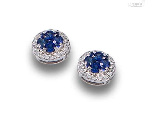 White gold earrings with sapphire bordered with diamonds.