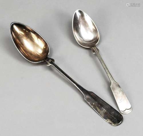 Two very large serving spoons, end