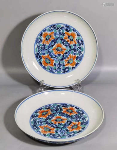 A pair of blue and white lotus plates with red and tangled b...
