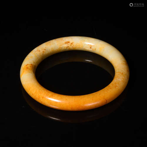 A Carved Russet Jade Bangle