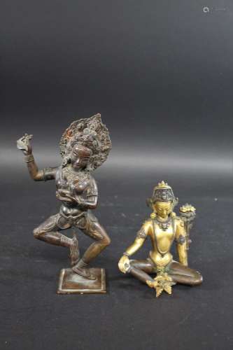 BRONZE BUDDHA probably Tibetan, the bronze figure holding a ...