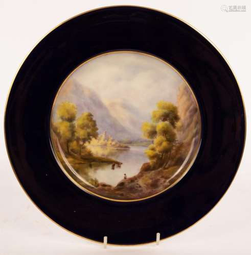 A Royal Worcester plate, 1922, painted a lake and mountain l...