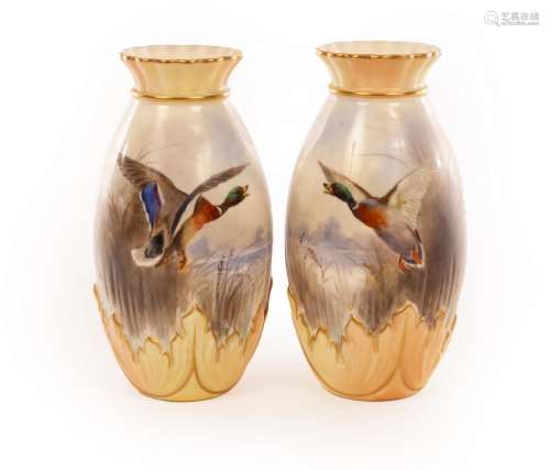 A pair of Royal Worcester baluster vases with gilt rimmed fr...